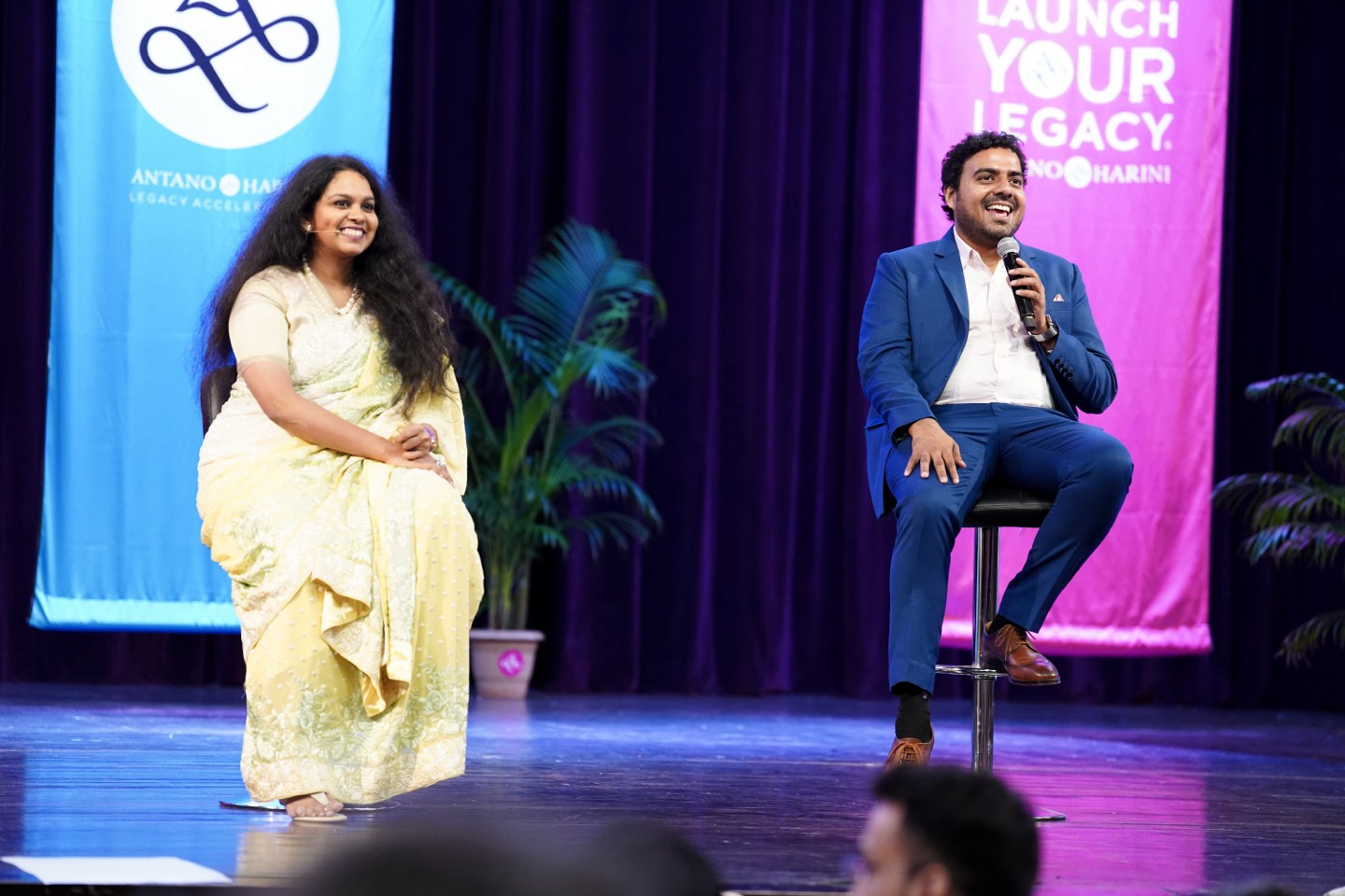 Antano Solar John and Harini Ramachandran on stage at a Launch Your Legacy event